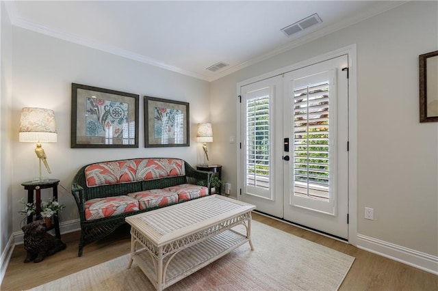 1021 Wetherby Way, Johns Creek, GA 30022 - living area featuring french doors, wood finished floors, crown molding, and baseboards