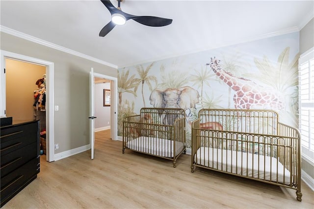 1021 Wetherby Way, Johns Creek, GA 30022 - bedroom with crown molding, wood finished floors, baseboards, a spacious closet, and a nursery area