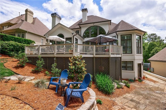 1021 Wetherby Way, Johns Creek, GA 30022 - rear view of house with a deck and roof with shingles