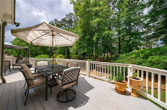 1021 Wetherby Way, Johns Creek, GA 30022 - wooden terrace featuring outdoor dining area and view of wooded area