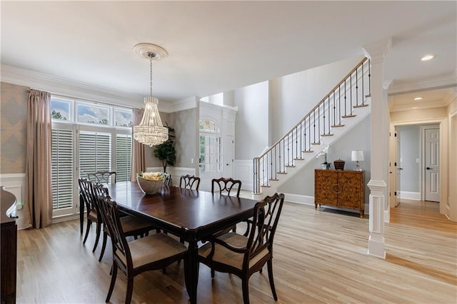 1021 Wetherby Way, Johns Creek, GA 30022 - dining room with a chandelier, light wood-style floors, stairs, crown molding, and a decorative wall