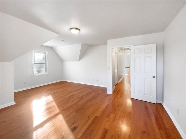 bonus room featuring hardwood / wood-style flooring and vaulted ceiling