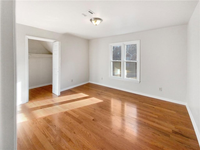 unfurnished bedroom with a closet and light wood-type flooring