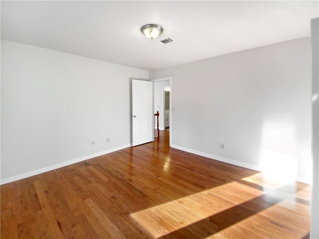 unfurnished room featuring hardwood / wood-style floors