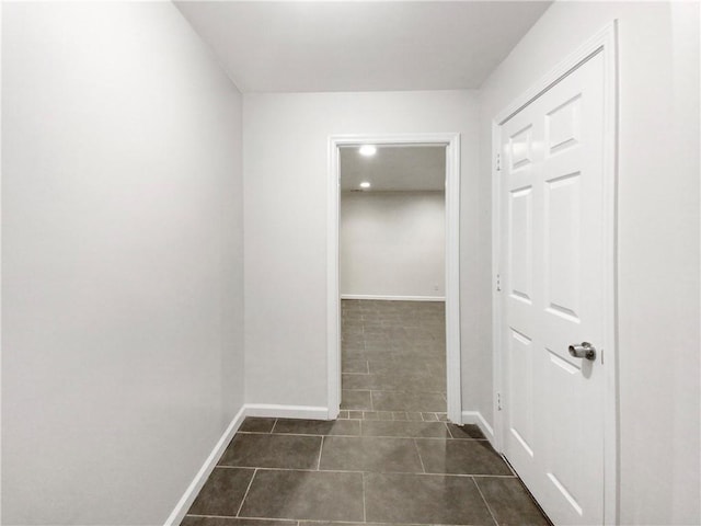 hallway with dark tile patterned floors