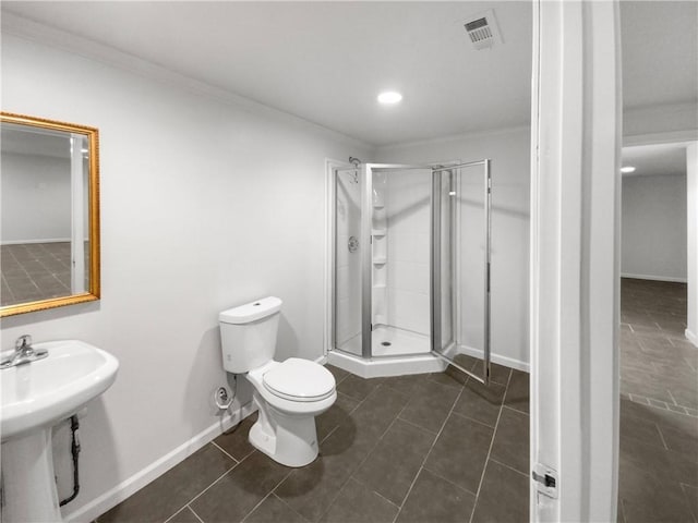 bathroom with toilet, a shower with door, ornamental molding, and tile patterned floors