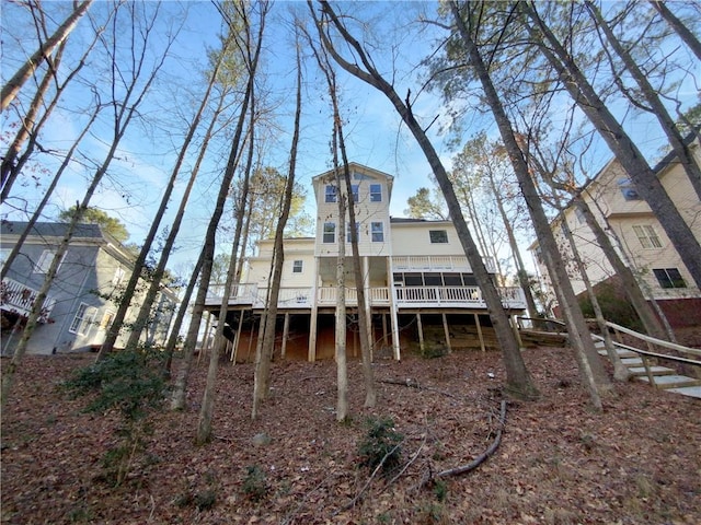 back of property with a sunroom