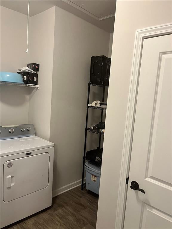 washroom with dark hardwood / wood-style flooring and washer / clothes dryer