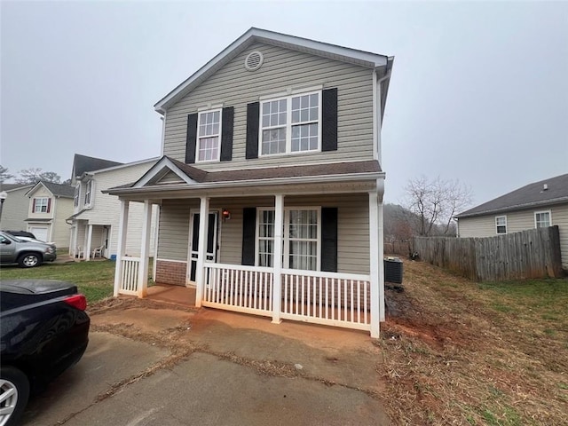 view of front property with covered porch and central air condition unit