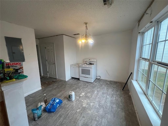 unfurnished dining area with a textured ceiling, electric panel, and a chandelier