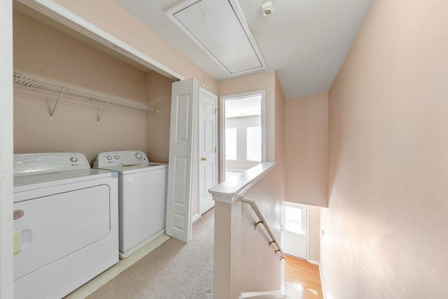 laundry room with laundry area, a healthy amount of sunlight, attic access, and washer and dryer