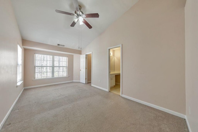 unfurnished bedroom with visible vents, baseboards, connected bathroom, carpet, and high vaulted ceiling