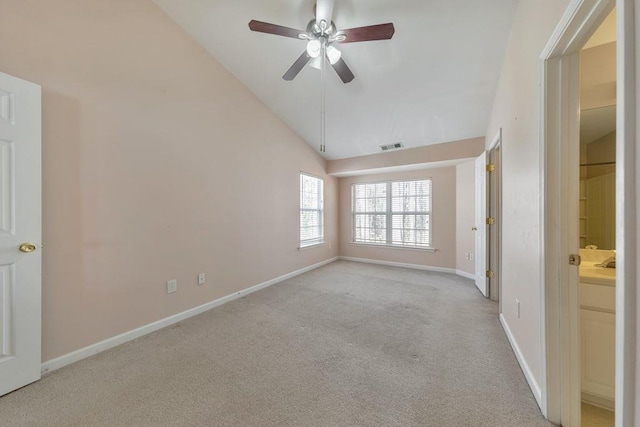 unfurnished room featuring ceiling fan, visible vents, baseboards, vaulted ceiling, and carpet