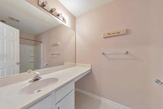 bathroom featuring visible vents, vanity, baseboards, and tile patterned floors