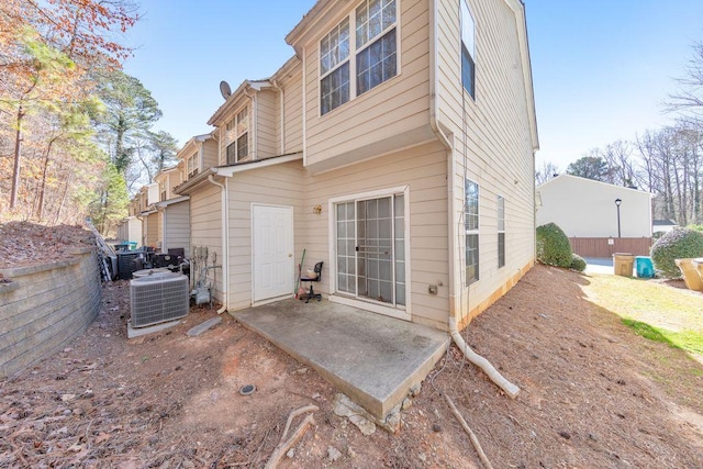 rear view of property with a patio area and central air condition unit