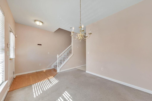 interior space with stairs, baseboards, and an inviting chandelier