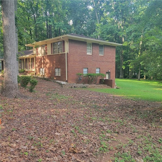 9278 Seminole Rd, Jonesboro, GA 30236 - view of property exterior featuring brick siding and a yard