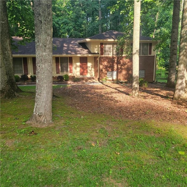 9278 Seminole Rd, Jonesboro, GA 30236 - split level home with brick siding and a front yard