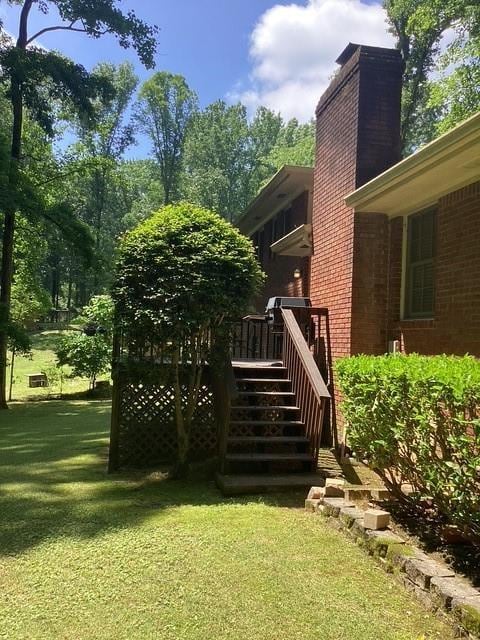 9278 Seminole Rd, Jonesboro, GA 30236 - view of grassy yard with a wooden deck and stairs