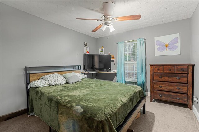 bedroom with ceiling fan, light carpet, and a textured ceiling