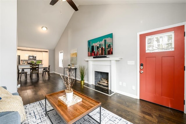 living room with beam ceiling, dark wood-type flooring, high vaulted ceiling, and ceiling fan