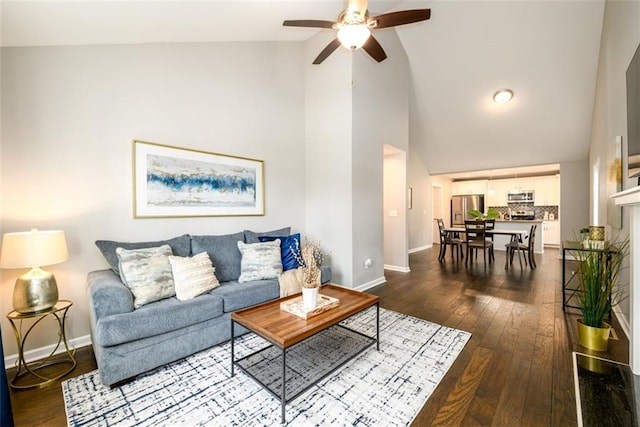 living room featuring hardwood / wood-style flooring, high vaulted ceiling, and ceiling fan