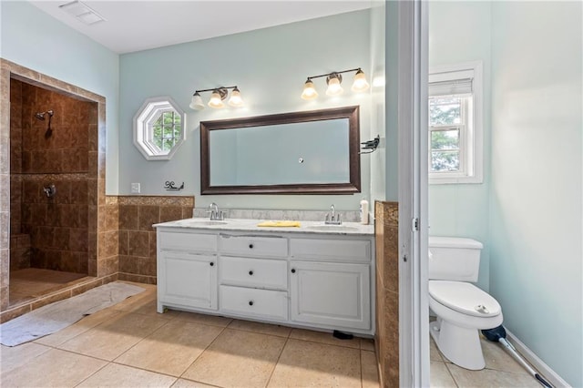 387 Lauren Marie Dr, Braselton, GA 30517 - full bathroom featuring double vanity, toilet, a walk in shower, and tile patterned floors