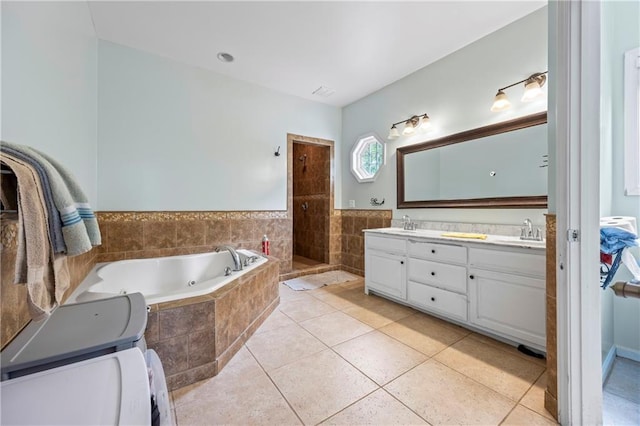 387 Lauren Marie Dr, Braselton, GA 30517 - bathroom featuring a jetted tub, double vanity, tiled shower, and tile patterned flooring