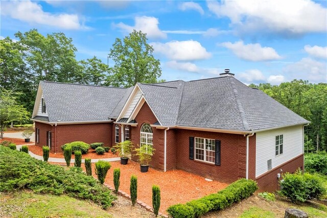 387 Lauren Marie Dr, Braselton, GA 30517 - view of front of property with brick siding, a chimney, and roof with shingles