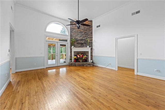 387 Lauren Marie Dr, Braselton, GA 30517 - unfurnished living room featuring a ceiling fan, light wood finished floors, high vaulted ceiling, baseboards, and crown molding