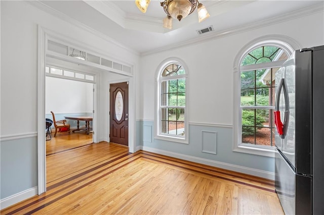 387 Lauren Marie Dr, Braselton, GA 30517 - entryway featuring light wood-type flooring, a tray ceiling, and crown molding