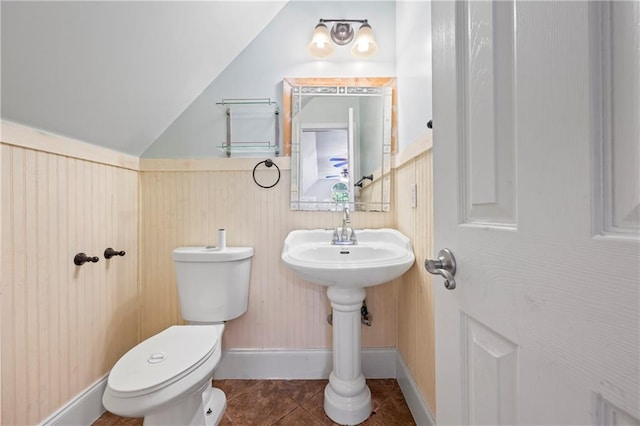 387 Lauren Marie Dr, Braselton, GA 30517 - bathroom featuring tile patterned flooring, toilet, a wainscoted wall, and lofted ceiling