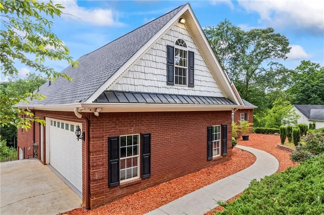 387 Lauren Marie Dr, Braselton, GA 30517 - view of side of property with a standing seam roof, brick siding, roof with shingles, concrete driveway, and metal roof
