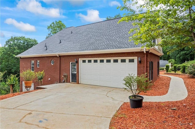 387 Lauren Marie Dr, Braselton, GA 30517 - view of home's exterior with brick siding, driveway, an attached garage, and a shingled roof