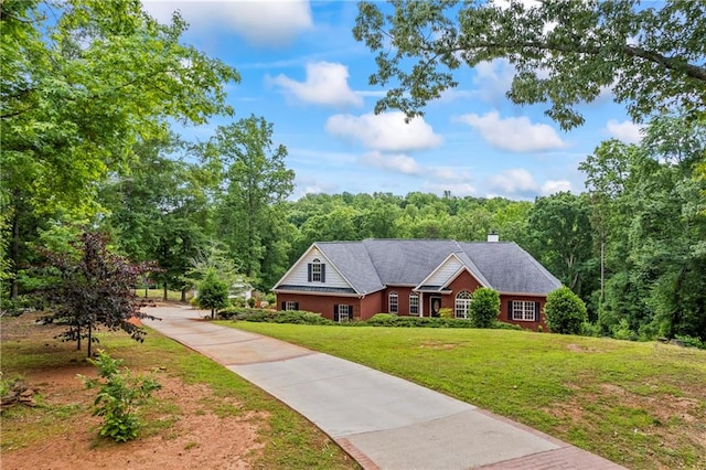 387 Lauren Marie Dr, Braselton, GA 30517 - view of front facade with driveway, a front lawn, a chimney, and a wooded view