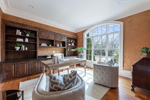 office space with light wood-style floors and ornamental molding