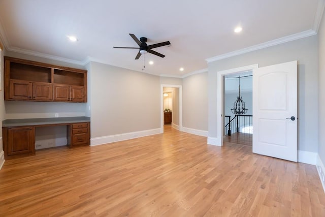 unfurnished living room featuring built in desk, light wood-type flooring, and baseboards