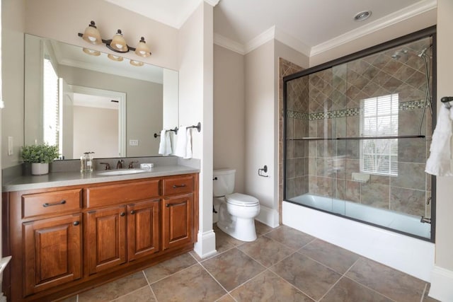 bathroom featuring tile patterned flooring, bath / shower combo with glass door, toilet, ornamental molding, and vanity