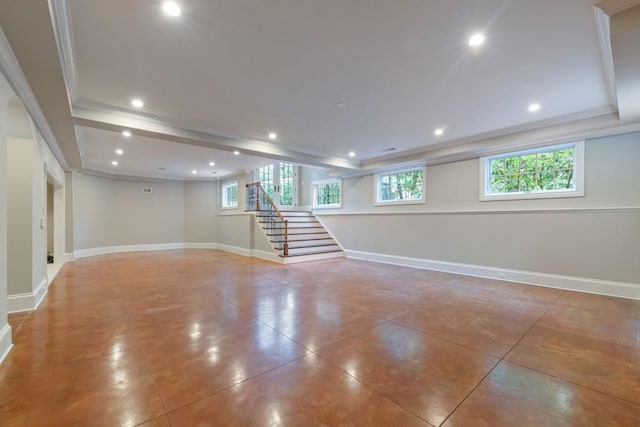 below grade area featuring plenty of natural light, stairway, and baseboards