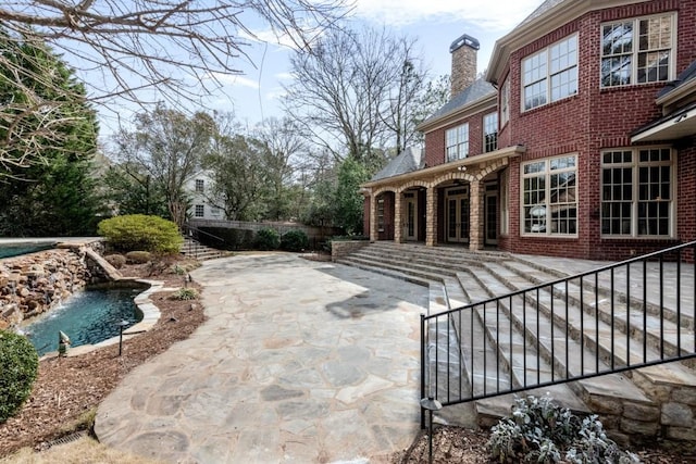 pool featuring a patio and stairs