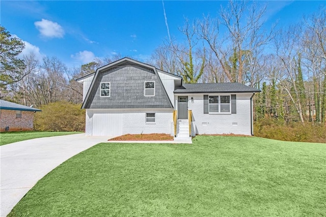 split level home with a garage and a front lawn