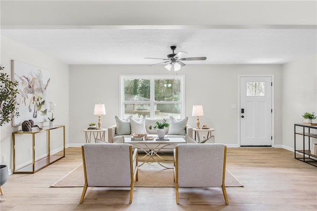 living room with ceiling fan and light hardwood / wood-style floors