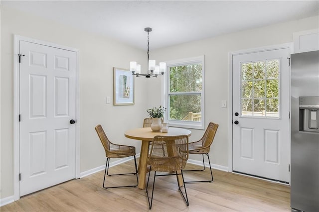 dining room with a notable chandelier and light hardwood / wood-style flooring