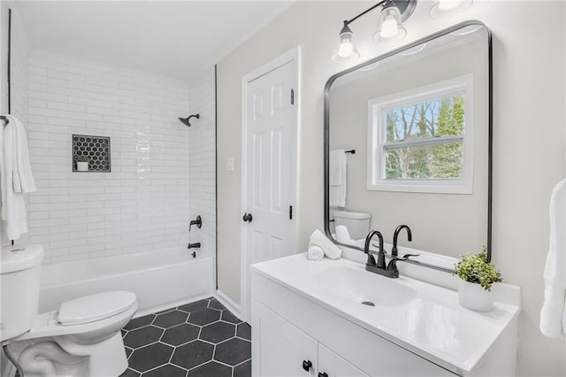 full bathroom with tiled shower / bath combo, vanity, tile patterned floors, and toilet