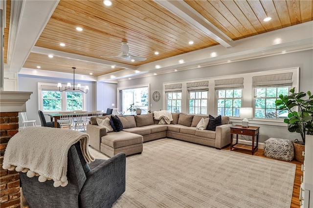 living room with wood ceiling, wood finished floors, and plenty of natural light