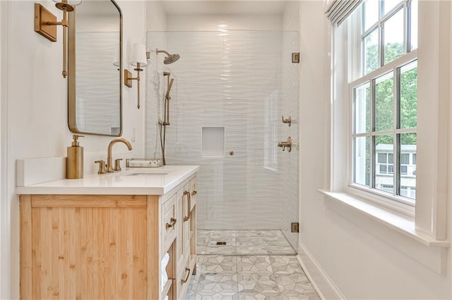 bathroom featuring a shower stall, a wealth of natural light, tile patterned flooring, and vanity