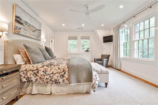 bedroom with visible vents, baseboards, recessed lighting, wood finished floors, and ornamental molding