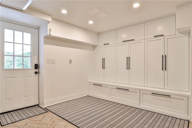 mudroom with baseboards, brick floor, and recessed lighting