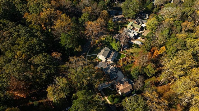 drone / aerial view with a wooded view