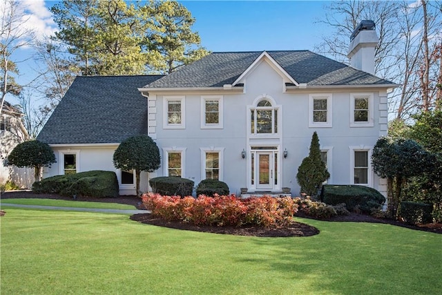 colonial home with a front lawn